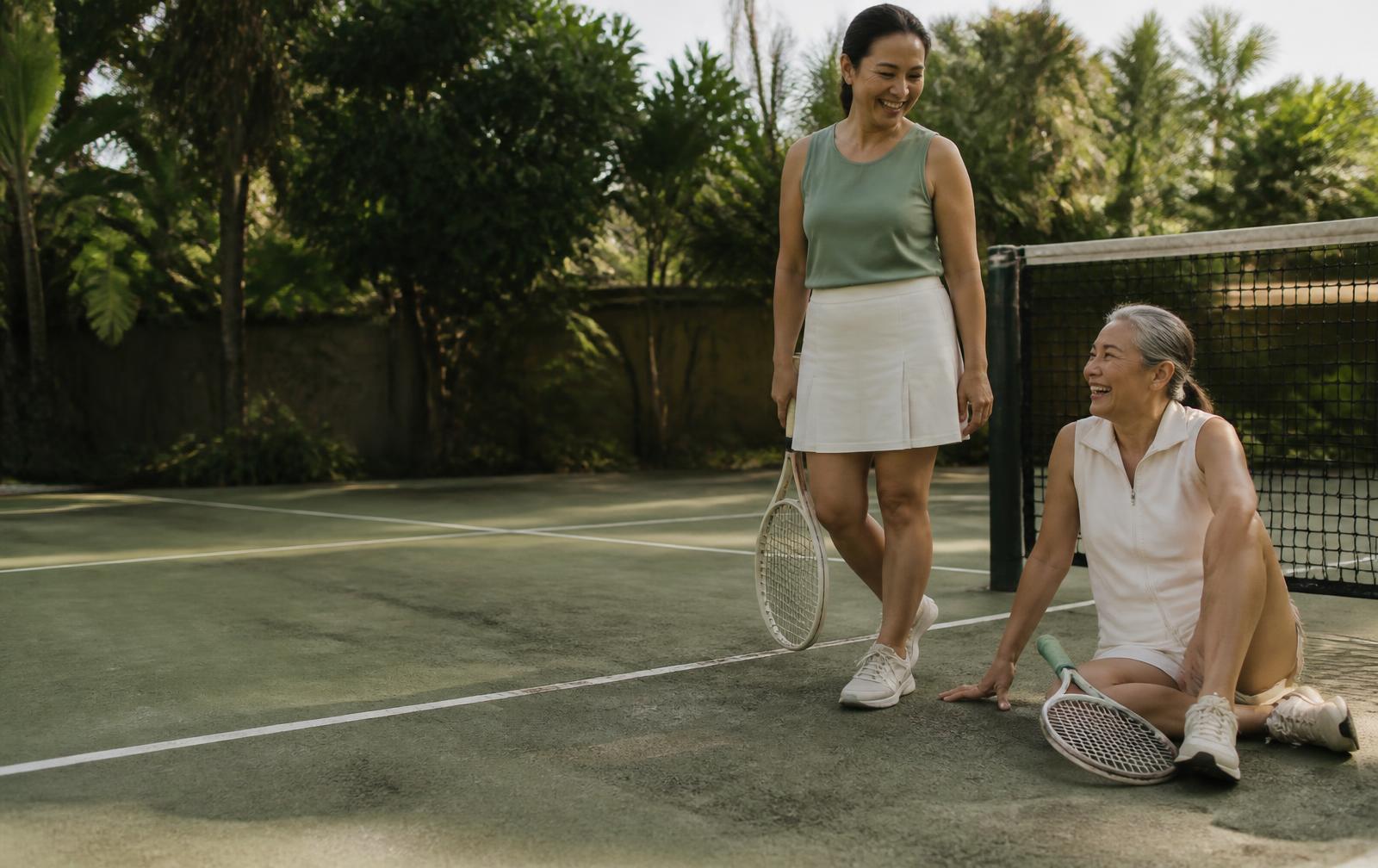 Temporary campaign concept showing two women relaxing on a tropical tennis court